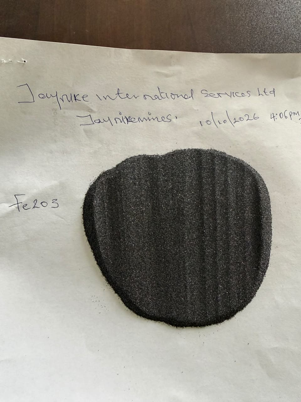 Iron oxide sample poured onto a dated and signed sheet of paper