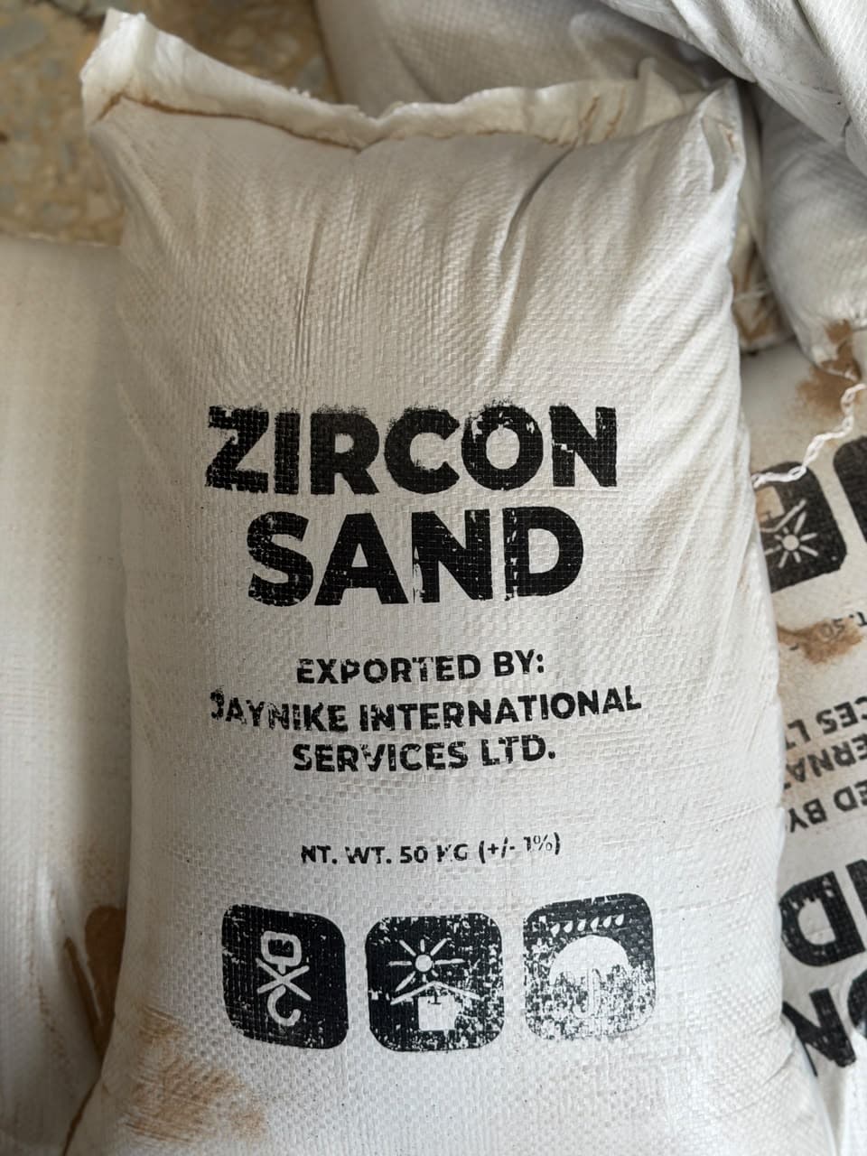 Close-up of a zircon sand bag marked 50 kg net weight, exported by JayNike International Services Ltd